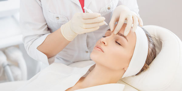 Woman receiving Botox injection in her frown lines