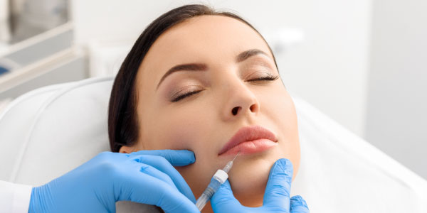 Woman receiving a lip injection at Beverly Hills Rejuvenation Center