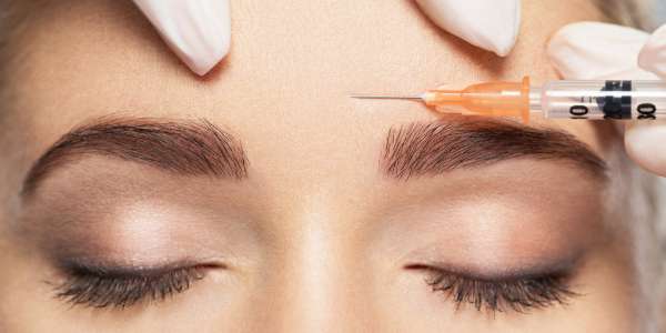 Women getting Botox in forehead 