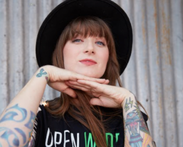 Hopdoddy employee with tattoos and wearing black hat