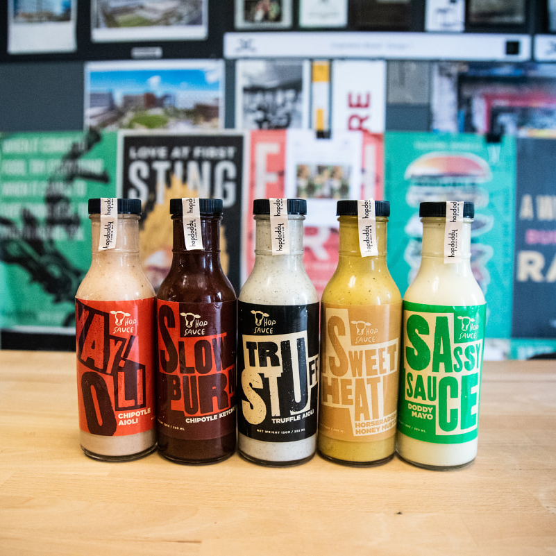 Lineup of signature Hopdoddy sauces to-go.
