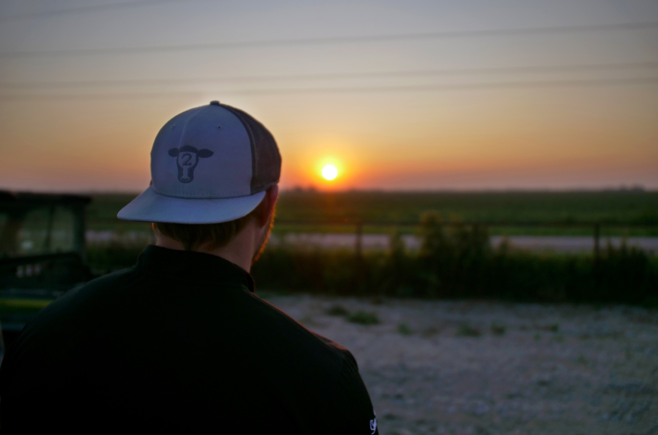 man in Hopdoddy hat at sunset