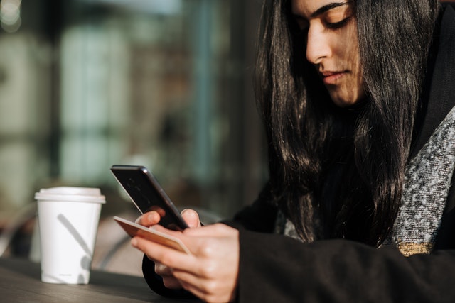 woman paying with credit card on phone