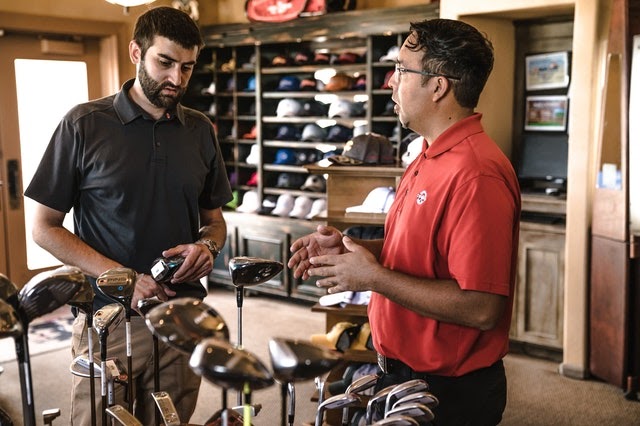 man shopping for golf clubs