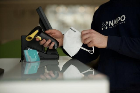 person holding mask and scanner