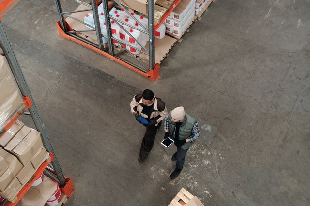 employees walking through inventory warehouse