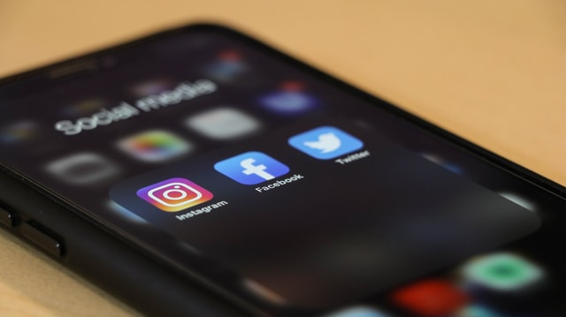 Instagram, Facebook, Twitter icons on smartphone