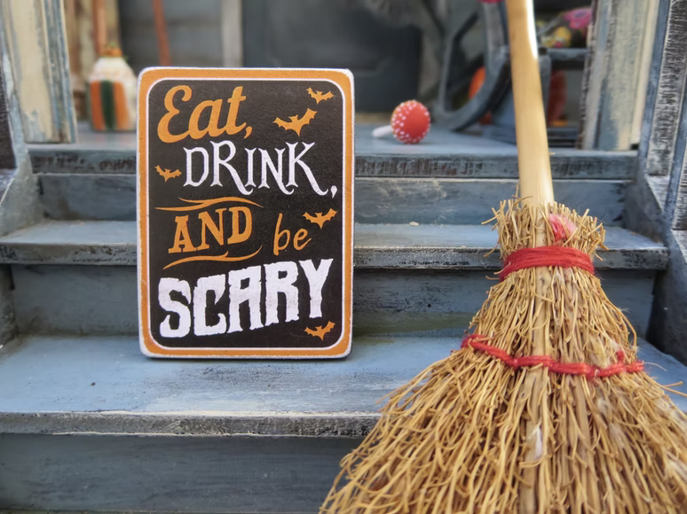 broom and eat, drink, and be scary sign