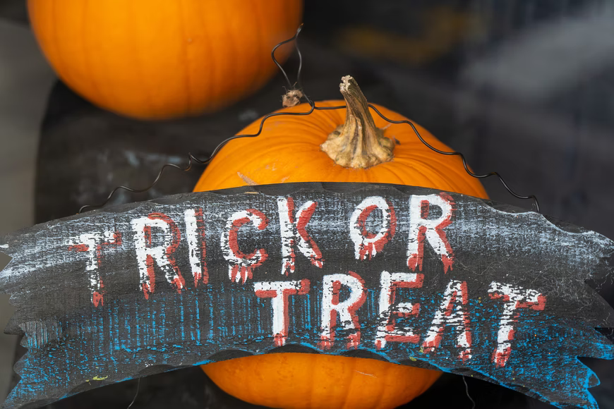 trick or treat sign with pumpkins for october marketing ideas