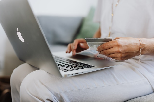 woman paying for things online with credit card