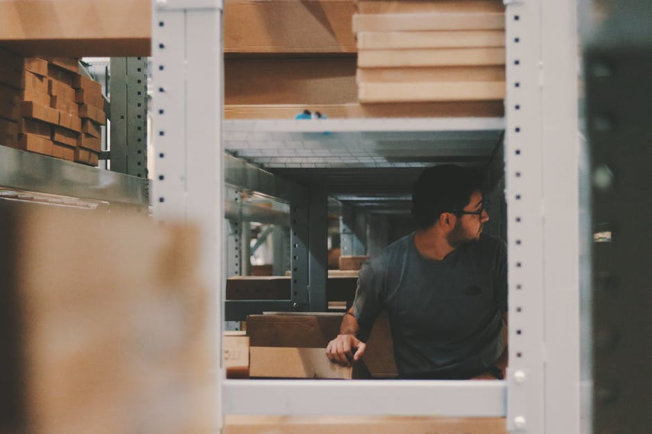 man looking through inventory at warehouse