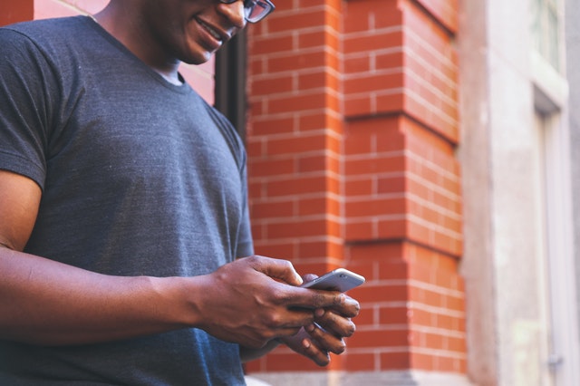 millennial man texting on phone