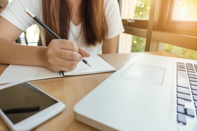 woman writing in notebook
