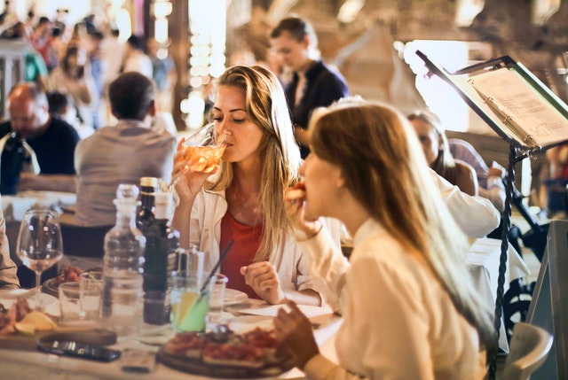 women drinking wine at restaurant