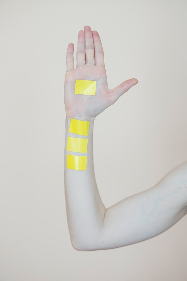 arm with yellow tape