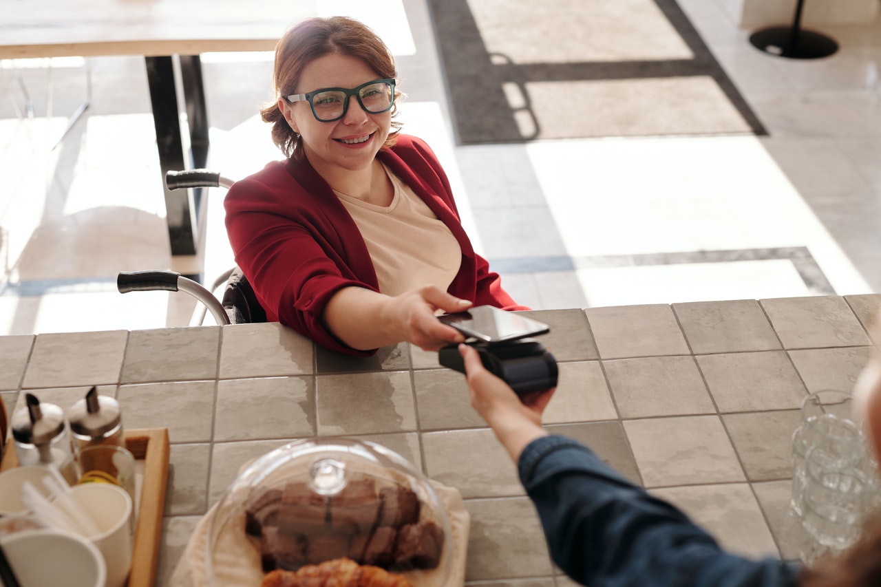 A customer paying via her mobile phone