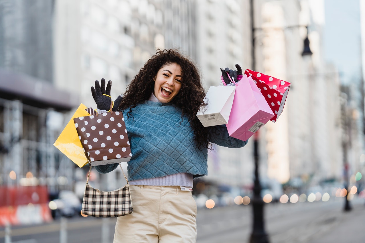 A happy customer carrying multiple shopping bags