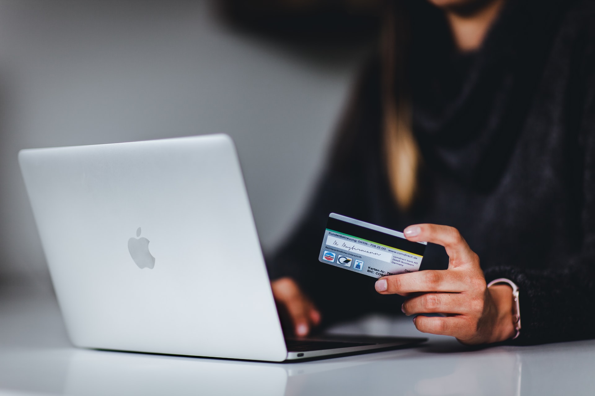 woman online shopping with credit card on laptop