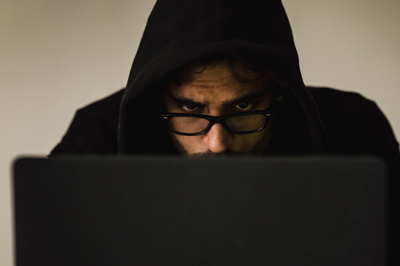 Scammer stealing information on laptop