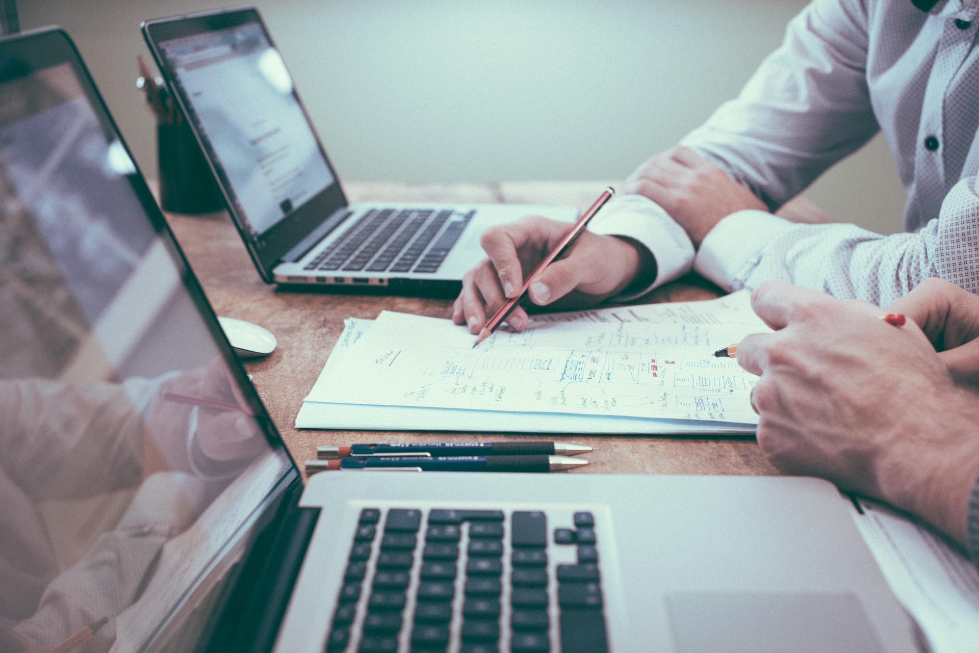 Entrepreneurs reviewing documents, paperwork, laptops