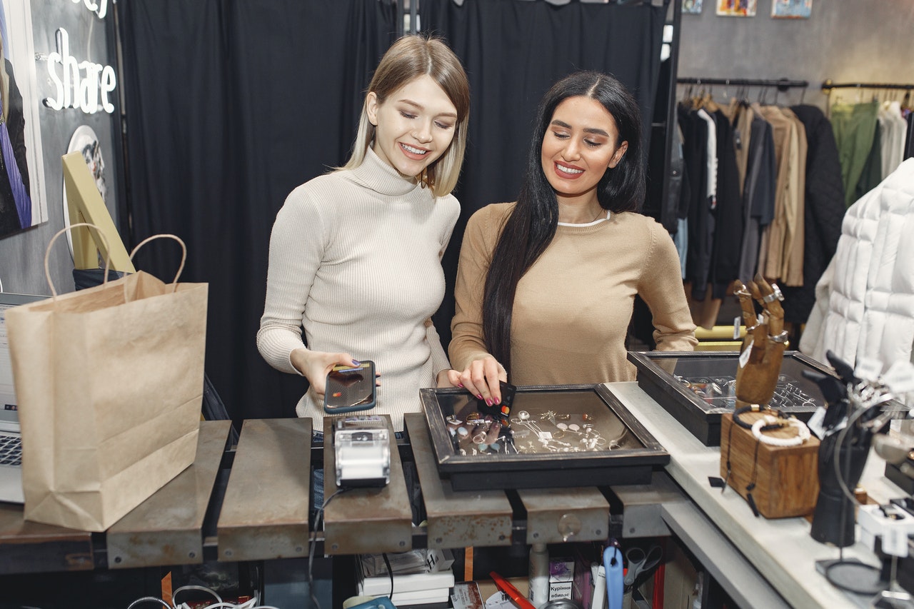 Customers paying via mobile phone at the front counter