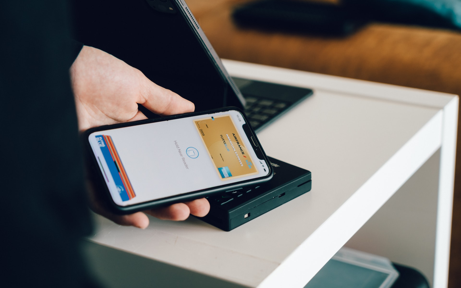 A customer paying using a mobile wallet on their phone