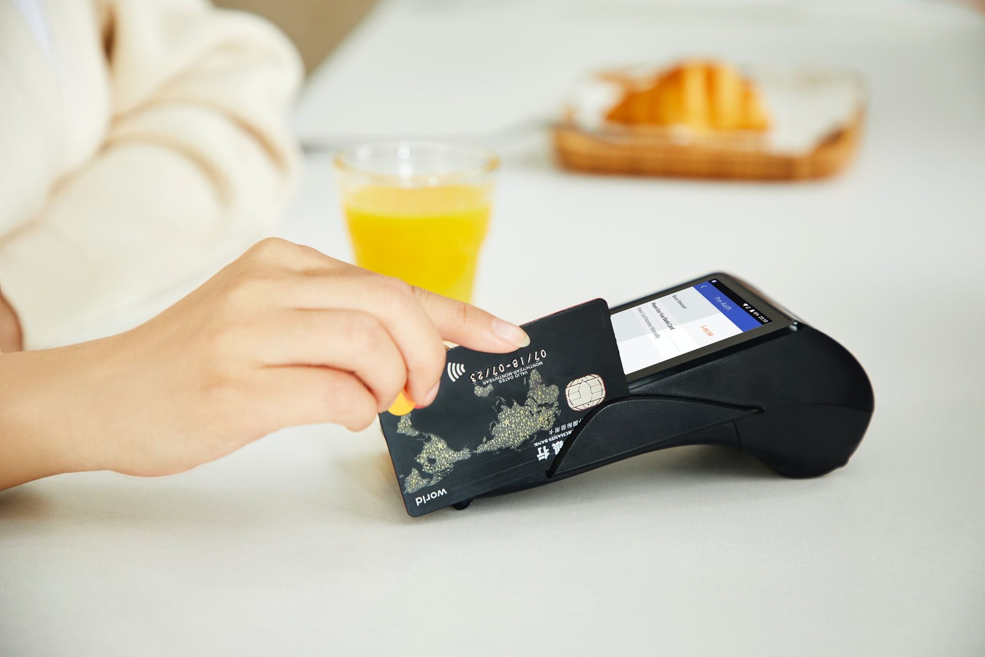 A customer paying via card at a POS system