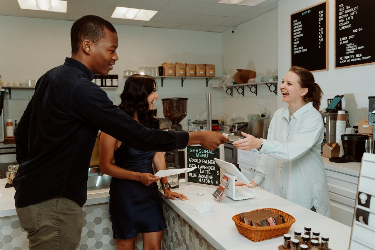 Loyal customers smiling happily with the cashier