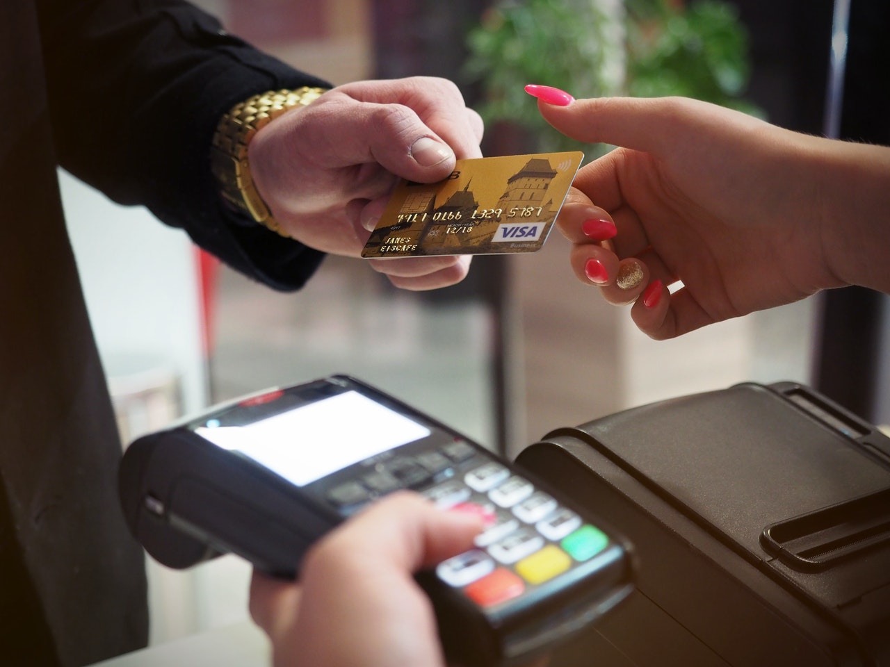 Customer handing a cashier their credit card