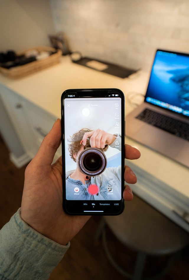 Man recording TikTok video content