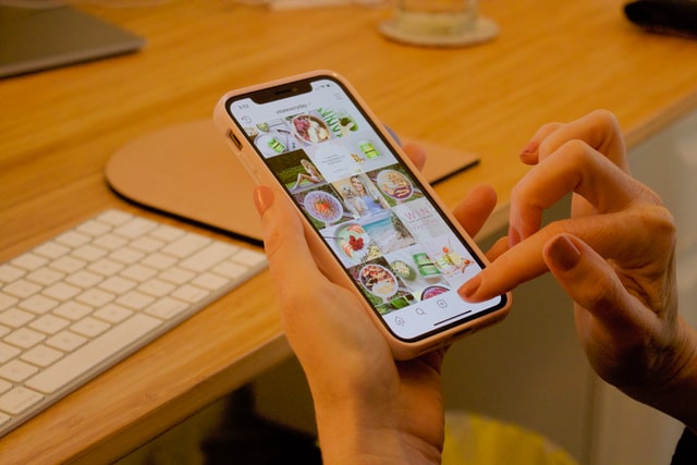 Woman scrolling through Instagram page feed