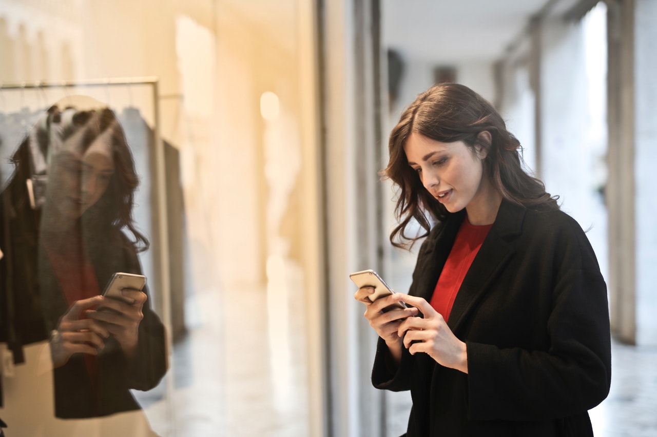 A woman checking shopping options on her phone