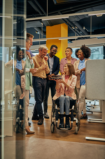 Woman in wheelchair celebrates work party