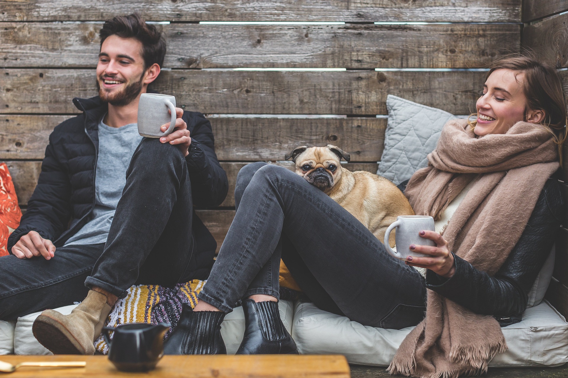 couple drinking coffee with pug