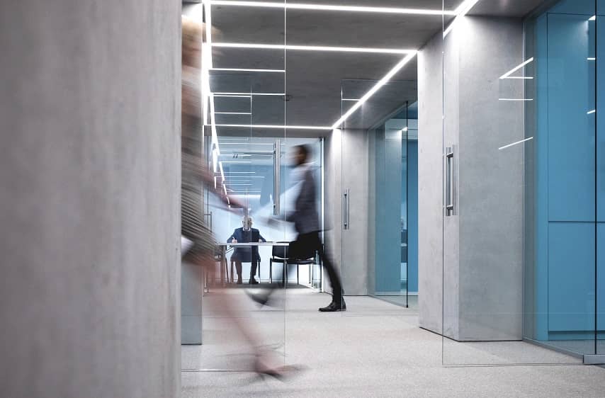 Man walking speedily across offices