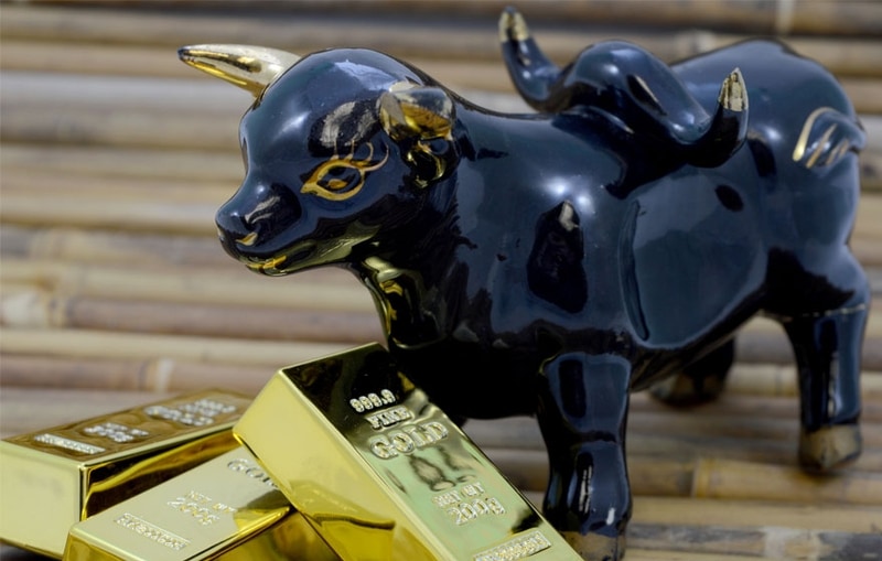 Bull statue with gold bricks