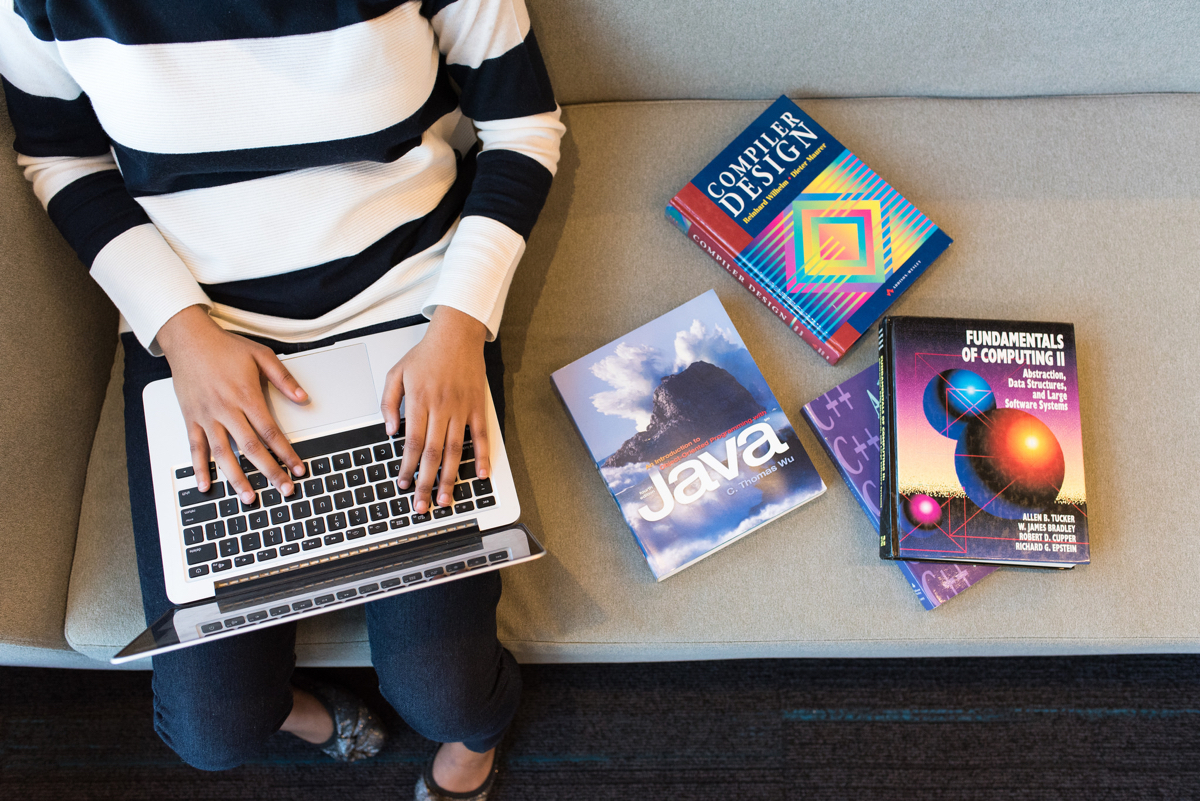 wocintechchat.com - IT Woman studying computer science books