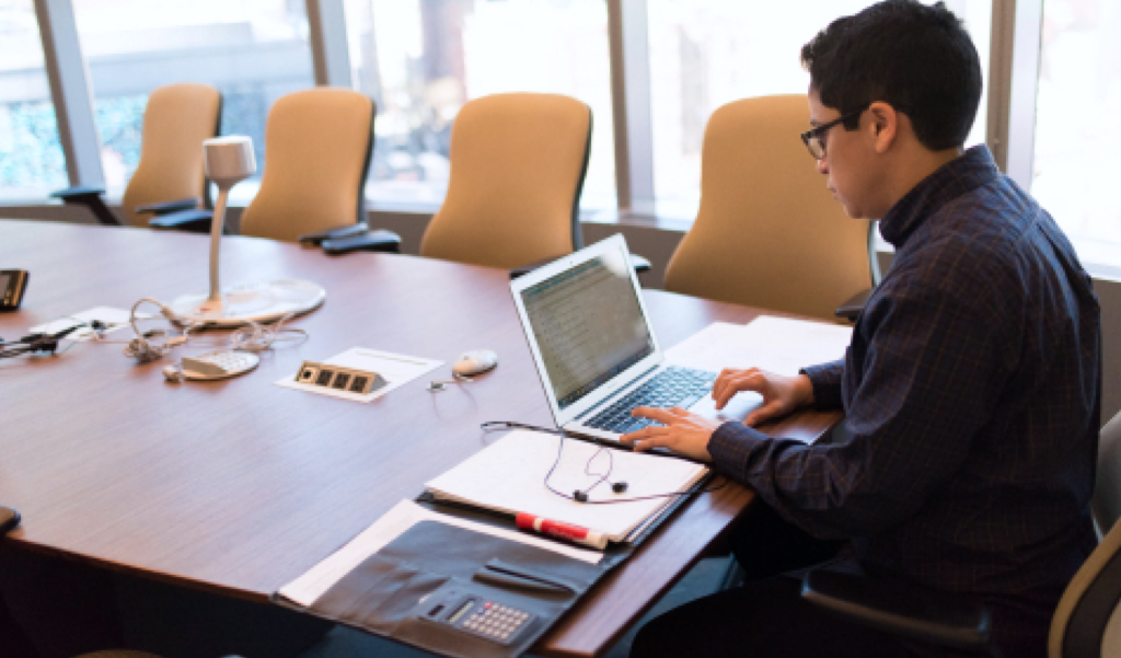 Man squatting in a conference room