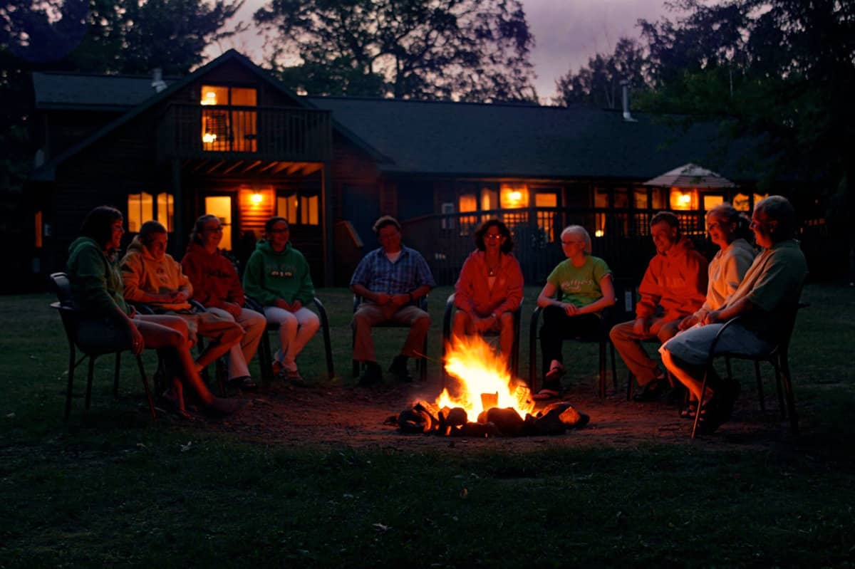 Family sitting around a campfire at Ruttger's