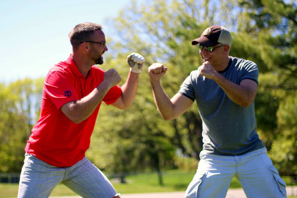 Two men facing off participating in group games
 