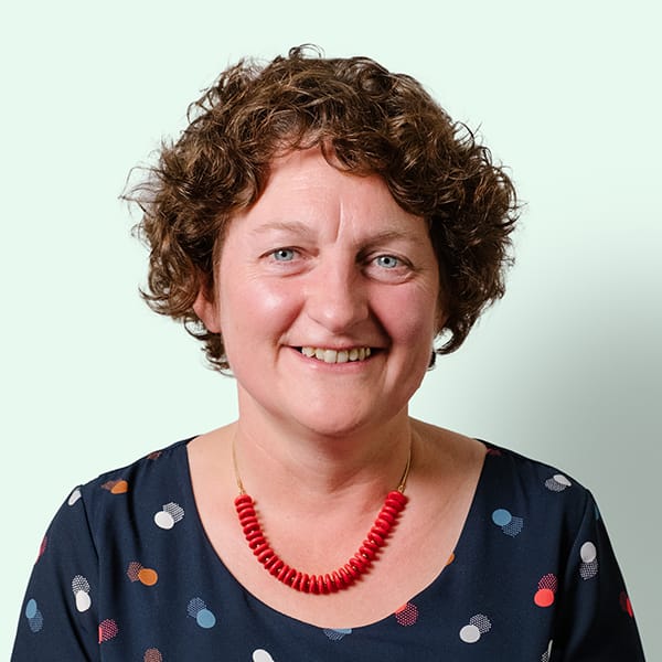 Profielfoto met groene achtergrond van Ten Anker teamlid Mieke Vanparijs