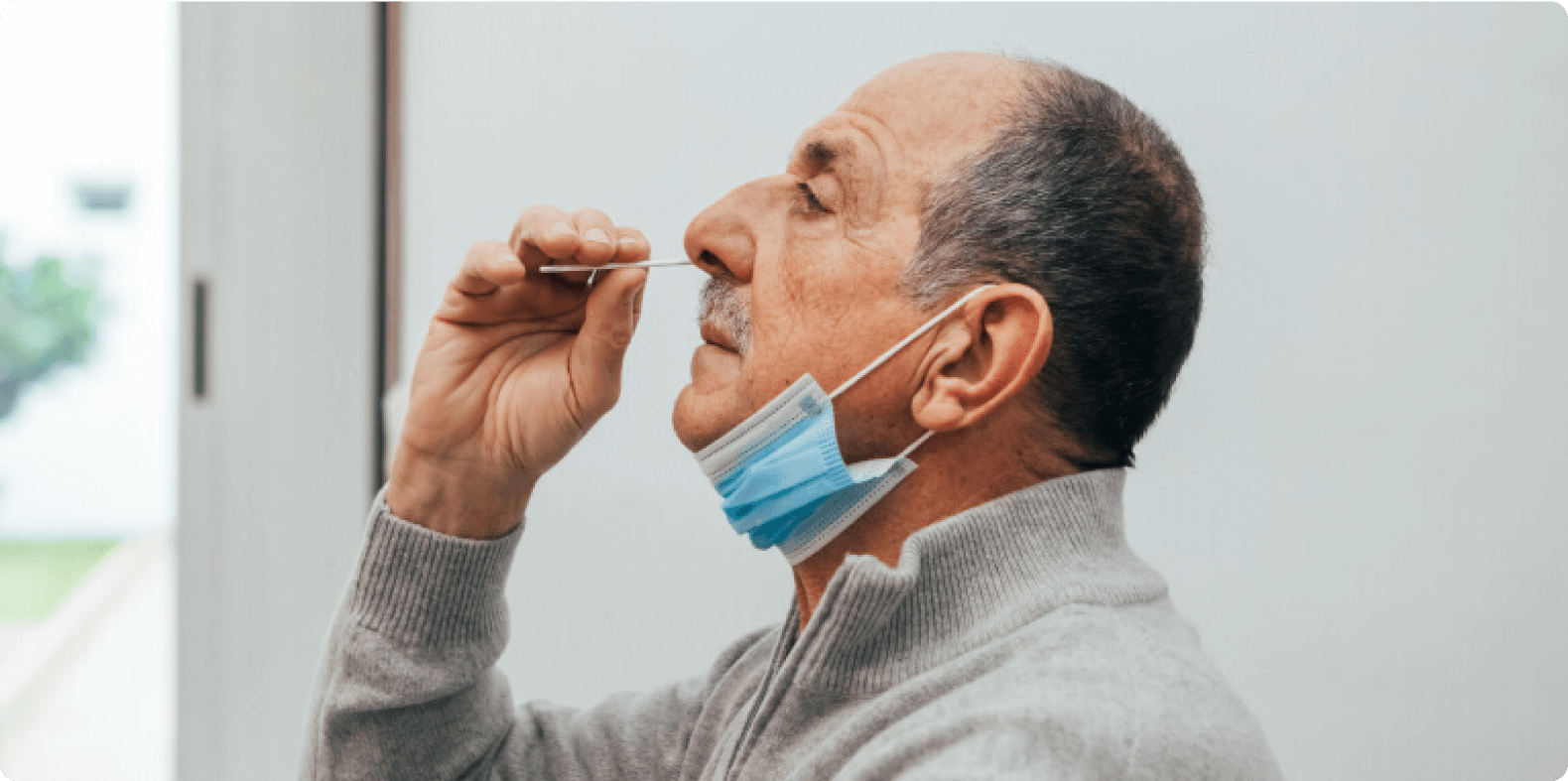 Man self-administering a rapid Covid-19 test