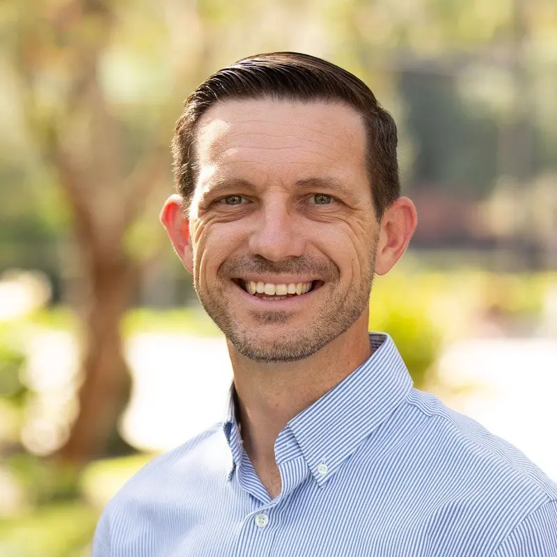 A man smiling as he poses for a photo.