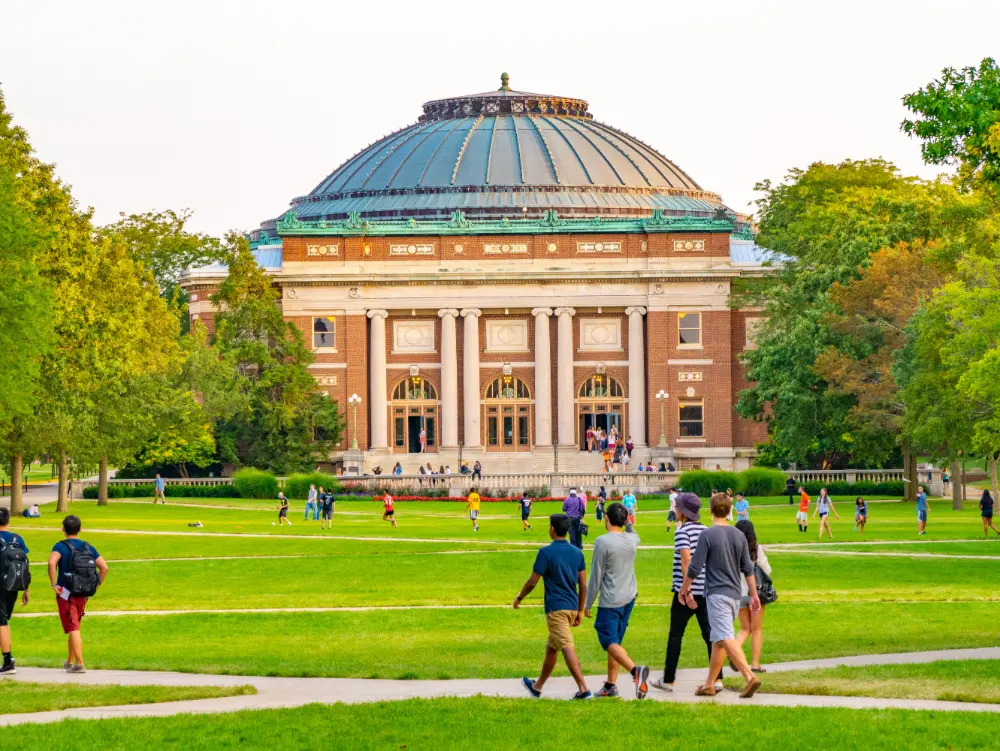 Students walking across a college campus.