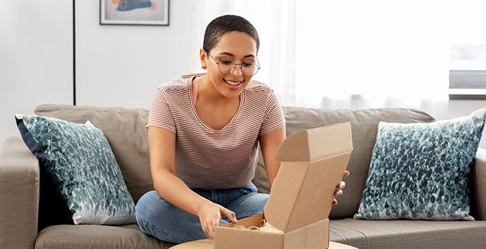 A customer opening up a package as a part of a subscription.
