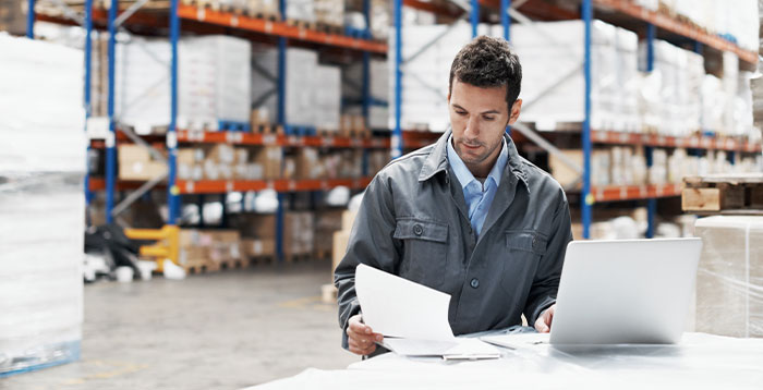 A man in a warehouse preparing online orders for customers