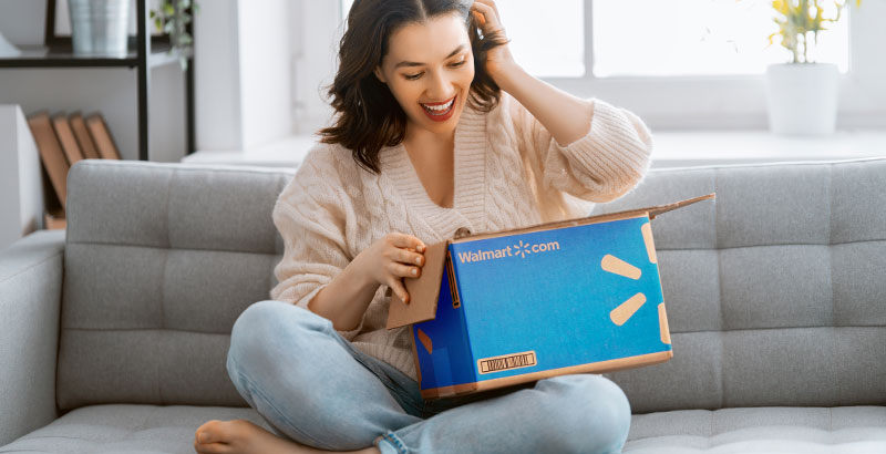 woman sitting on couch working on computer
