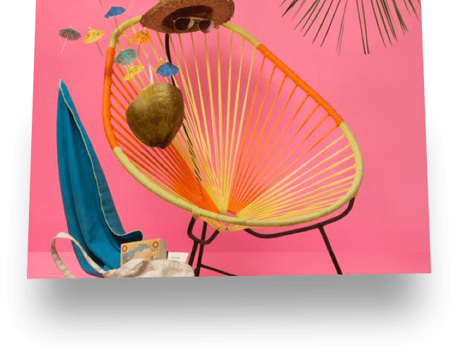 an avocado shaped straw chair with an invisible man wearing glasses and a straw hat sitting on it