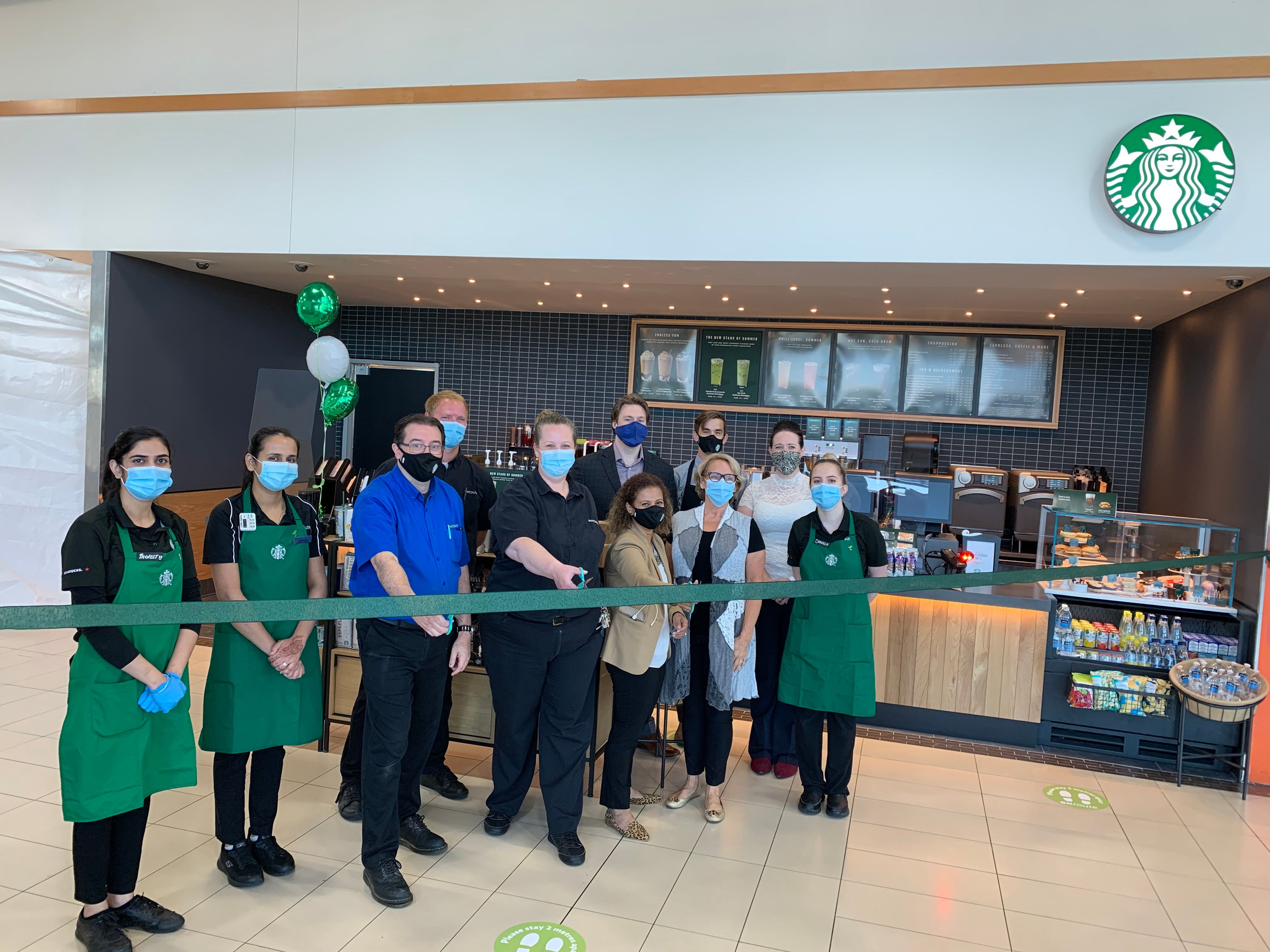 Employees outside of Starbucks storefront