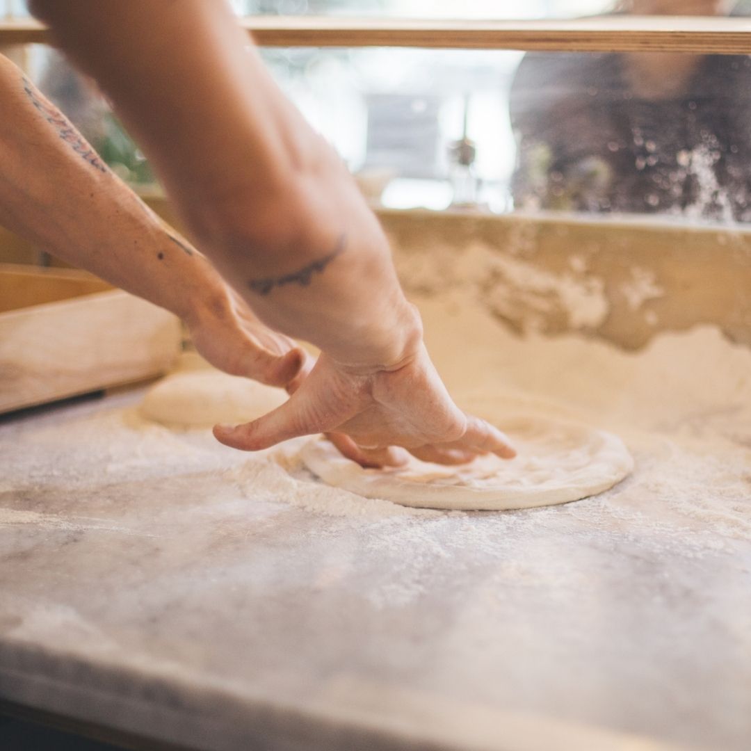 pizzaiolo with dough
